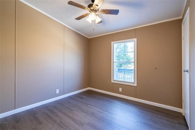 spare room featuring crown molding, a textured ceiling, dark wood-type flooring, and ceiling fan