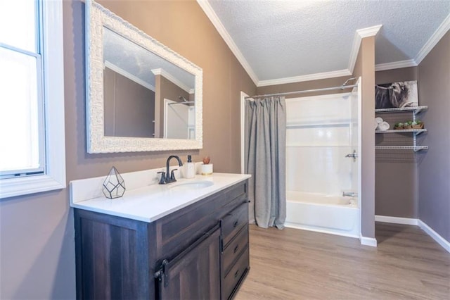 bathroom with vanity, shower / bathtub combination with curtain, a textured ceiling, and hardwood / wood-style floors