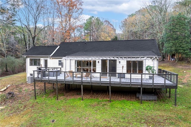 rear view of property with a yard and a deck