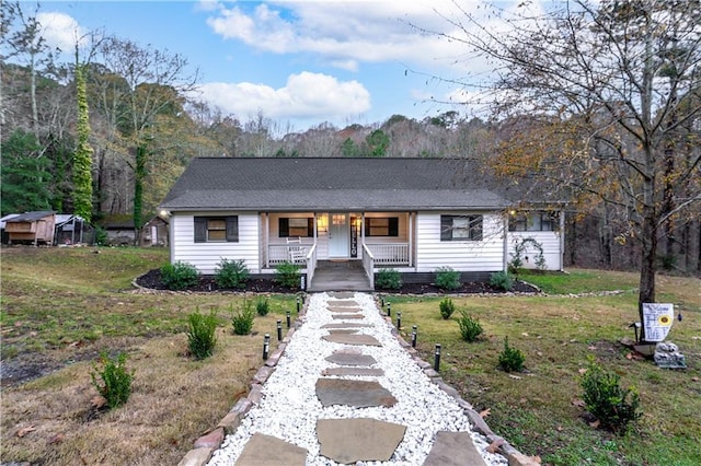 single story home with a front yard and a porch