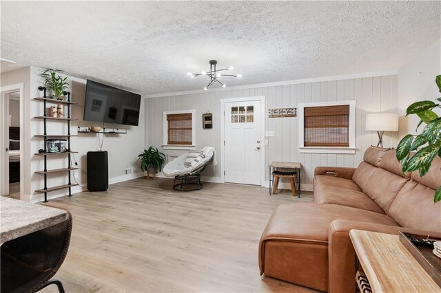 kitchen featuring a center island, light hardwood / wood-style flooring, pendant lighting, white cabinets, and appliances with stainless steel finishes