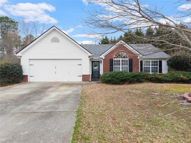 ranch-style home featuring an attached garage, a shingled roof, concrete driveway, and brick siding