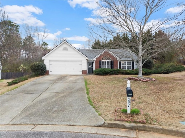 ranch-style home featuring an attached garage, brick siding, fence, driveway, and a front yard