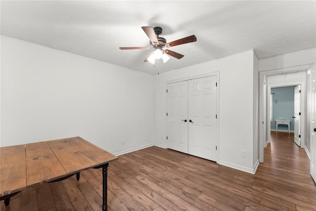 office with ceiling fan, baseboards, and wood finished floors