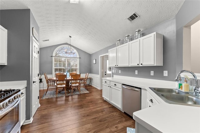 kitchen with visible vents, lofted ceiling, appliances with stainless steel finishes, dark wood-style flooring, and a sink