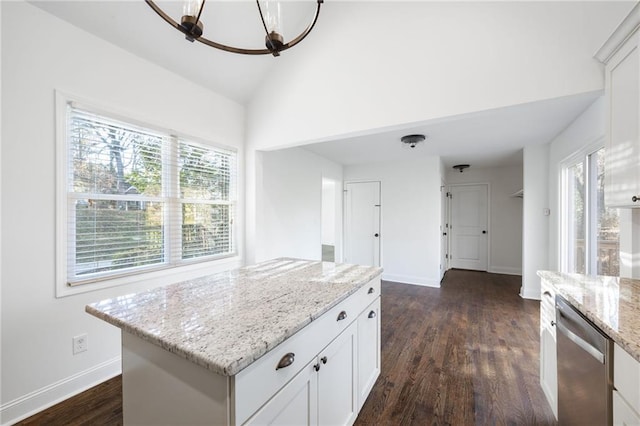 kitchen with baseboards, white cabinets, dishwasher, dark wood-type flooring, and vaulted ceiling