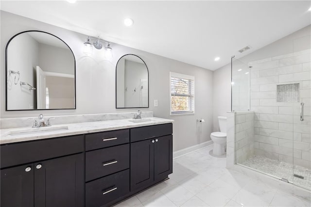 full bath featuring a stall shower, lofted ceiling, a sink, and toilet