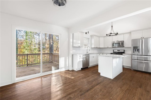 kitchen featuring dark wood-style floors, a kitchen island, stainless steel appliances, white cabinetry, and a sink