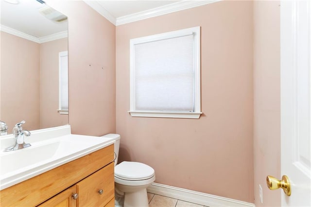 bathroom featuring crown molding, toilet, vanity, tile patterned flooring, and baseboards