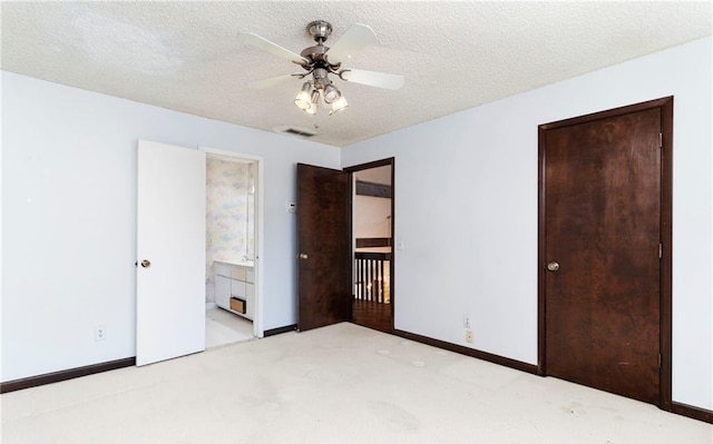 unfurnished bedroom featuring baseboards, visible vents, a textured ceiling, and carpet flooring