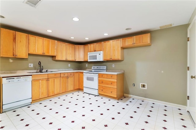 kitchen with light countertops, white appliances, a sink, and visible vents