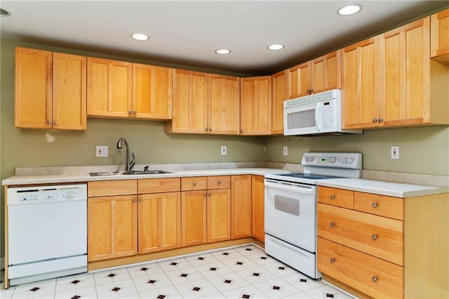 kitchen with recessed lighting, light countertops, light brown cabinets, a sink, and white appliances