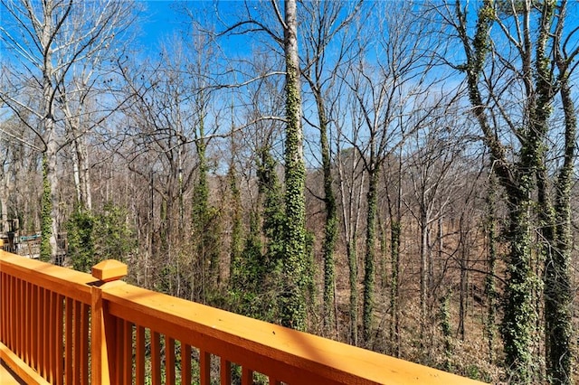 wooden deck with a view of trees