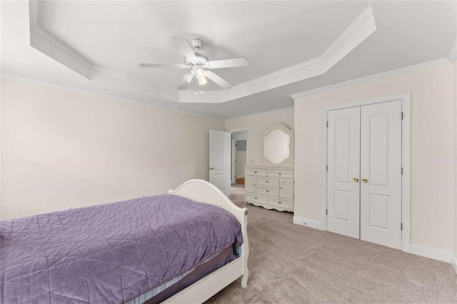 4514 Walking Stick Ln, Gainesville, GA 30506 - carpeted bedroom featuring a tray ceiling, ornamental molding, ceiling fan, and a closet