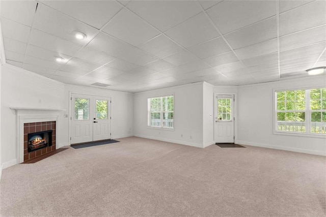 4514 Walking Stick Ln, Gainesville, GA 30506 - unfurnished living room with a drop ceiling, baseboards, carpet flooring, and a tiled fireplace