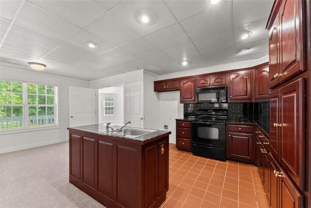 4514 Walking Stick Ln, Gainesville, GA 30506 - kitchen featuring black appliances, dark countertops, a sink, decorative backsplash, and an island with sink