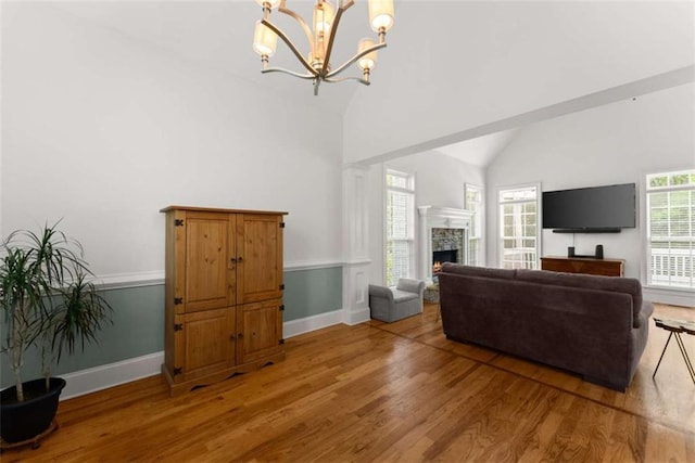 4514 Walking Stick Ln, Gainesville, GA 30506 - living room with light wood-type flooring, a chandelier, a fireplace, baseboards, and high vaulted ceiling