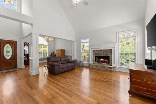 4514 Walking Stick Ln, Gainesville, GA 30506 - living room with high vaulted ceiling, wood finished floors, a stone fireplace, a chandelier, and ceiling fan