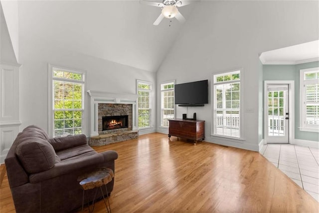 4514 Walking Stick Ln, Gainesville, GA 30506 - living room with high vaulted ceiling, a fireplace, ceiling fan, light wood-style floors, and baseboards