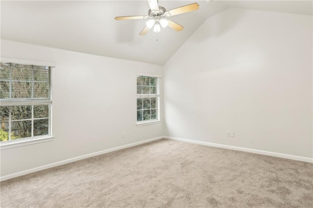 empty room with carpet floors, vaulted ceiling, and ceiling fan