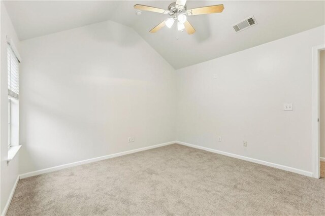 unfurnished room featuring vaulted ceiling, ceiling fan, and light carpet