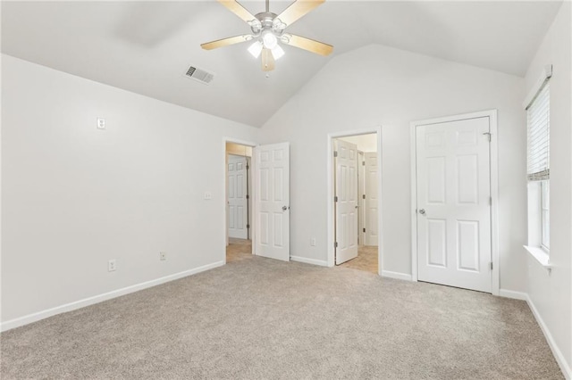 unfurnished bedroom featuring ceiling fan, light colored carpet, and lofted ceiling