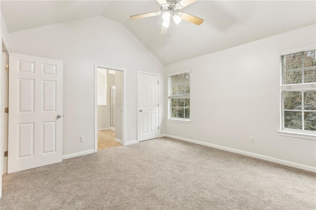 unfurnished bedroom featuring ceiling fan, vaulted ceiling, and light carpet