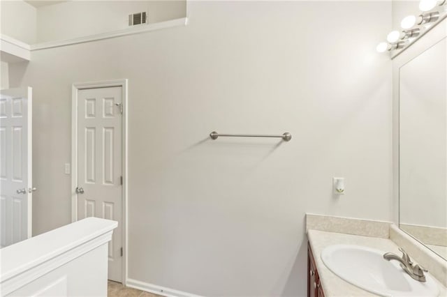 bathroom with tile patterned flooring and vanity