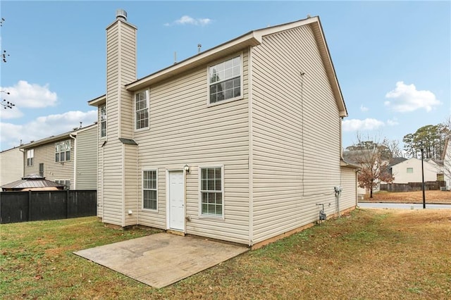 back of property featuring a patio and a yard