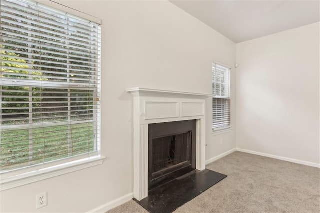 unfurnished living room with light colored carpet