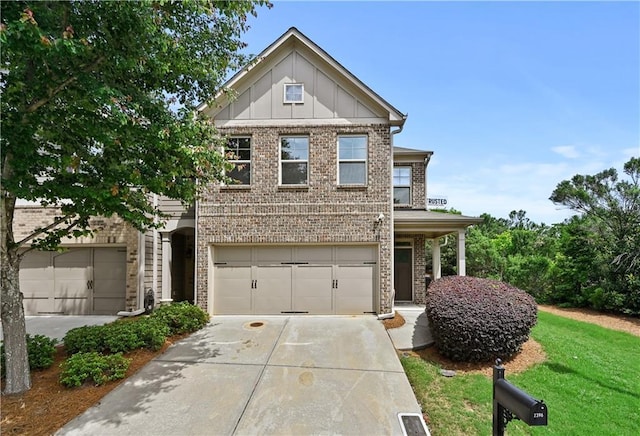 2396 Whiteoak Bnd SE Unit 16, Smyrna, GA 30080 - view of front of house with brick siding, board and batten siding, concrete driveway, and an attached garage