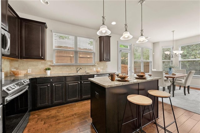 2396 Whiteoak Bnd SE Unit 16, Smyrna, GA 30080 - kitchen featuring appliances with stainless steel finishes, hardwood / wood-style flooring, backsplash, light stone counters, and recessed lighting