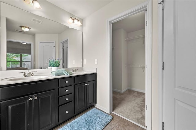 2396 Whiteoak Bnd SE Unit 16, Smyrna, GA 30080 - full bathroom featuring double vanity, tile patterned flooring, baseboards, and a walk in closet