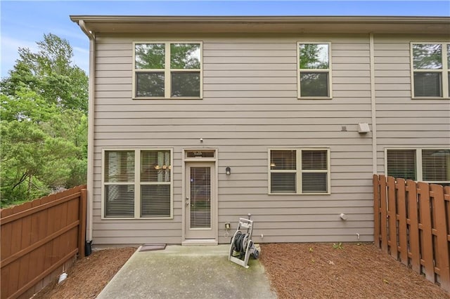 2396 Whiteoak Bnd SE Unit 16, Smyrna, GA 30080 - rear view of house with a fenced backyard and a patio area