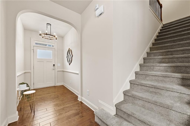2396 Whiteoak Bnd SE Unit 16, Smyrna, GA 30080 - foyer entrance with arched walkways, hardwood / wood-style flooring, stairway, a chandelier, and baseboards