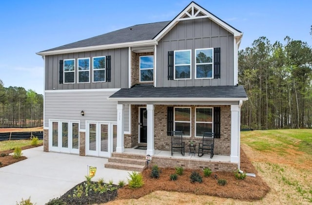 734 Great Oak Pl, Villa Rica, GA 30180 - craftsman house with concrete driveway, board and batten siding, a front lawn, brick siding, and covered porch