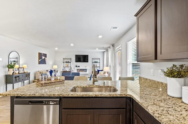 734 Great Oak Pl, Villa Rica, GA 30180 - kitchen with dark brown cabinetry, a peninsula, visible vents, stainless steel dishwasher, and a sink