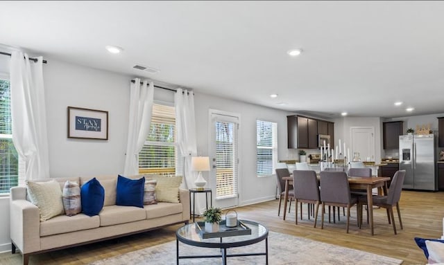 734 Great Oak Pl, Villa Rica, GA 30180 - living area featuring light wood-style flooring, baseboards, visible vents, and recessed lighting