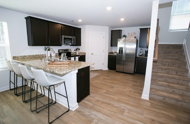734 Great Oak Pl, Villa Rica, GA 30180 - kitchen with a peninsula, baseboards, and appliances with stainless steel finishes