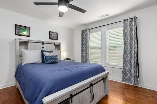 bedroom featuring dark hardwood / wood-style floors and ceiling fan