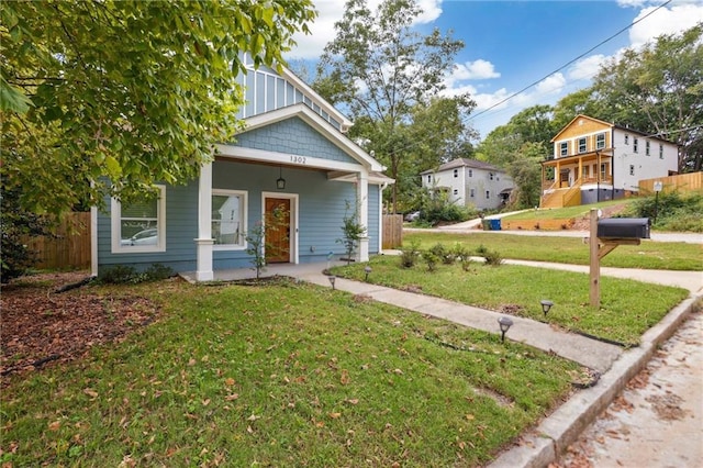 bungalow-style home with a front lawn and a porch