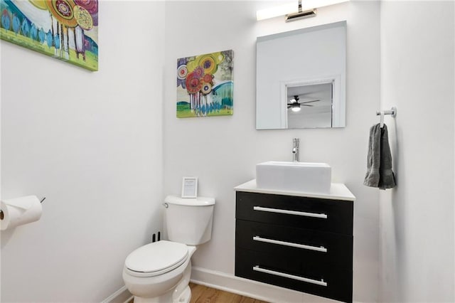 bathroom featuring hardwood / wood-style floors, toilet, and vanity