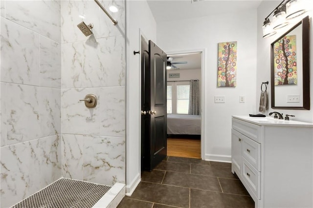 bathroom featuring a tile shower, tile patterned floors, and vanity