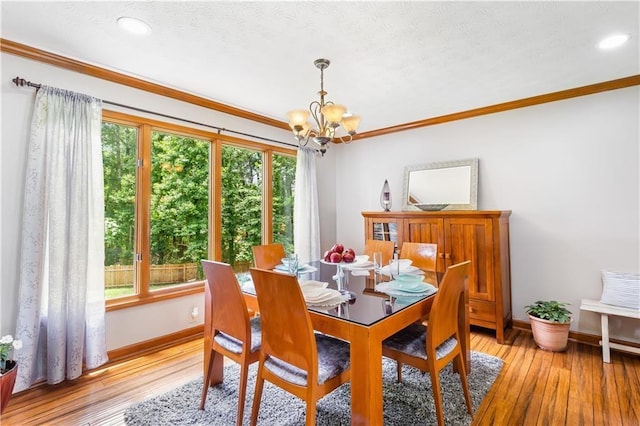 599 Palmer Ct SE, Conyers, GA 30094 - dining room with plenty of natural light, ornamental molding, light hardwood / wood-style flooring, and an inviting chandelier