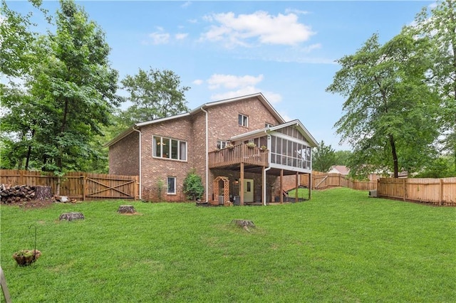 back of house featuring a sunroom and a yard