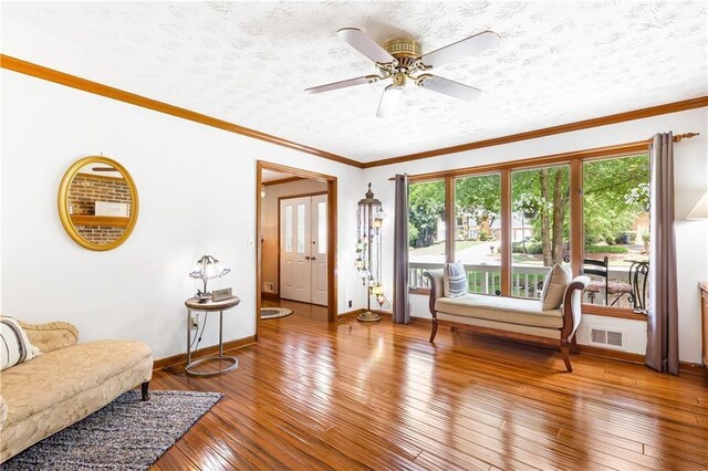 599 Palmer Ct SE, Conyers, GA 30094 - living room with wood-type flooring, ceiling fan, and crown molding