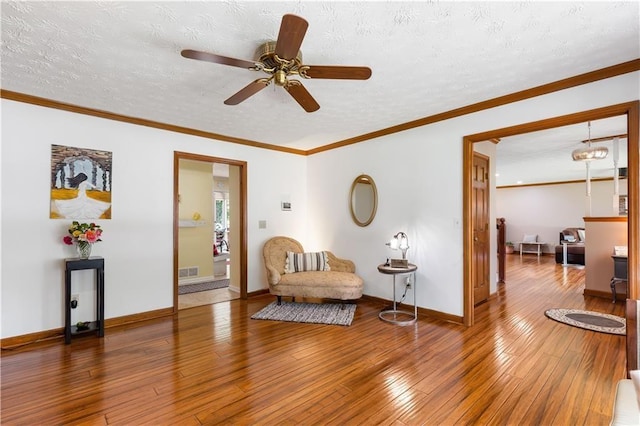 599 Palmer Ct SE, Conyers, GA 30094 - living area featuring crown molding, hardwood / wood-style flooring, ceiling fan, and a textured ceiling