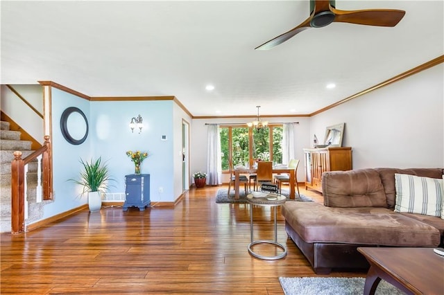 599 Palmer Ct SE, Conyers, GA 30094 - living room featuring crown molding, ceiling fan with notable chandelier, and hardwood / wood-style floors