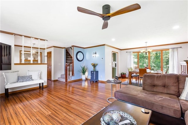 599 Palmer Ct SE, Conyers, GA 30094 - living room with wood-type flooring, ornamental molding, and ceiling fan with notable chandelier