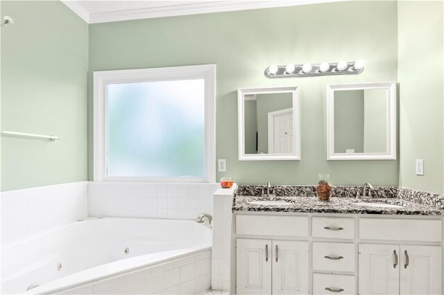 full bathroom featuring a sink, double vanity, ornamental molding, and a whirlpool tub